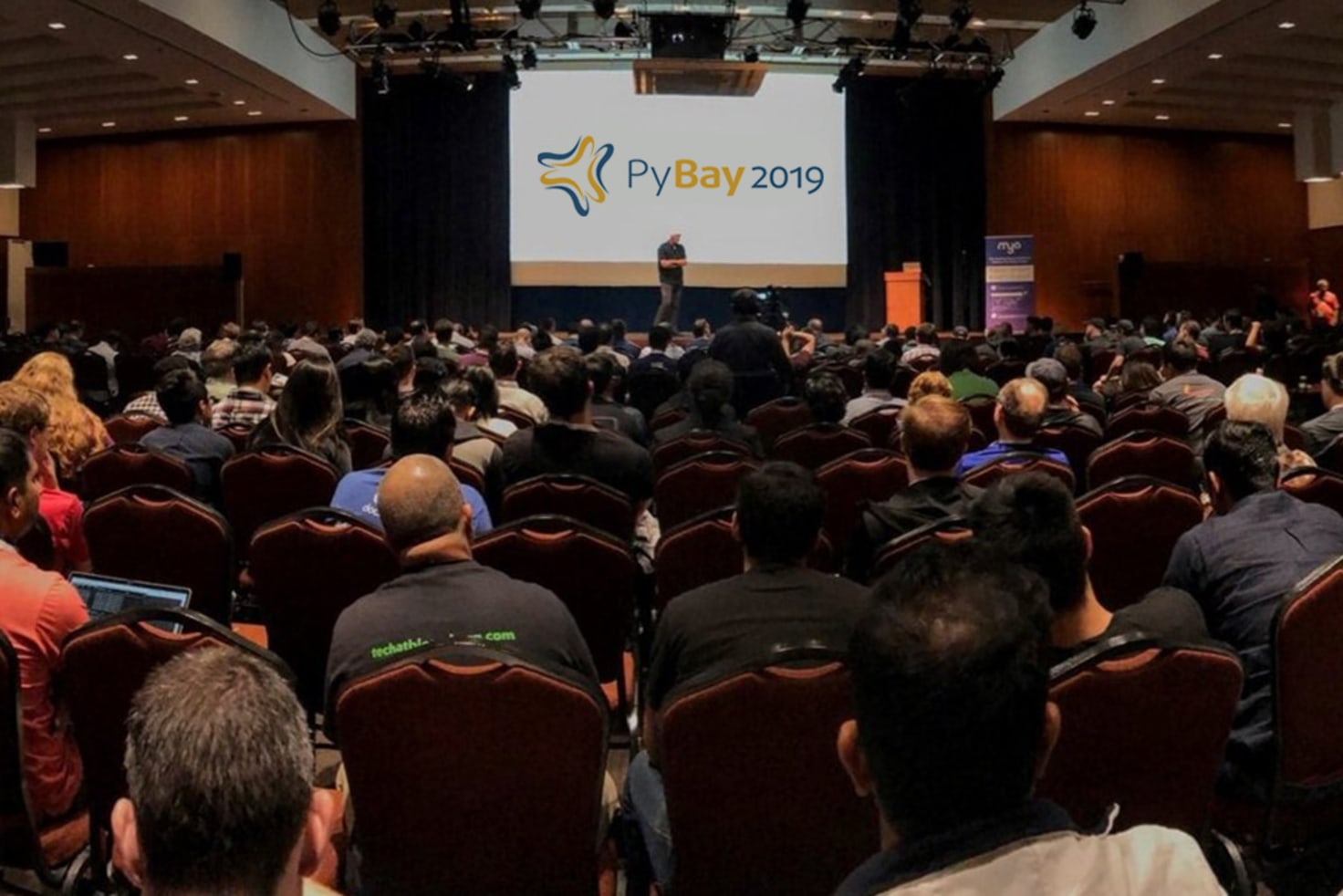 Panel members of the Python Steering Council engaged in a thoughtful discussion at PyBay2019, with audience members in attendance, reflecting the collaborative spirit of the Python community.