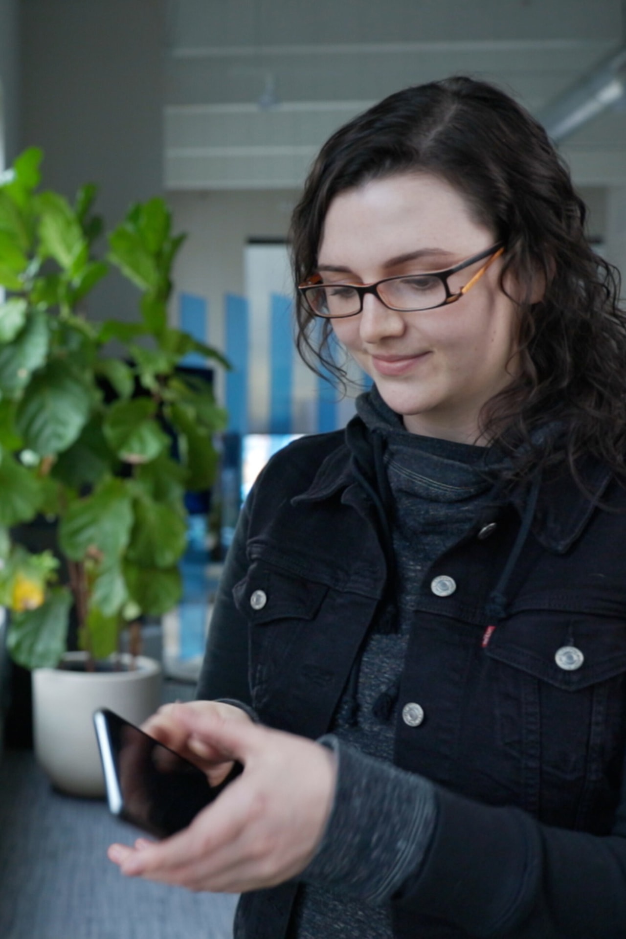 Andrea selects a test iOS device from the testing wall at our Denver offices.