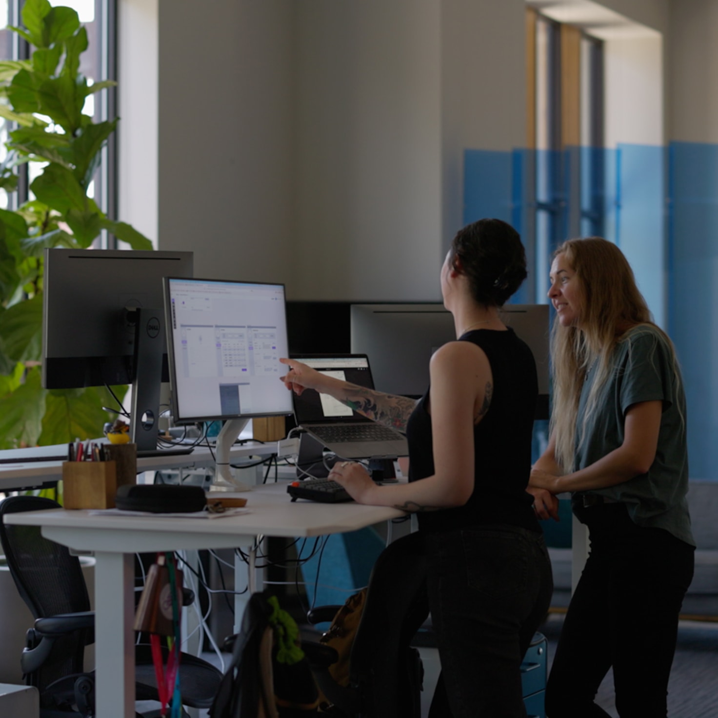 Andrea and Sara look over the interface design of a new software project for a customer in the Life Sciences industry