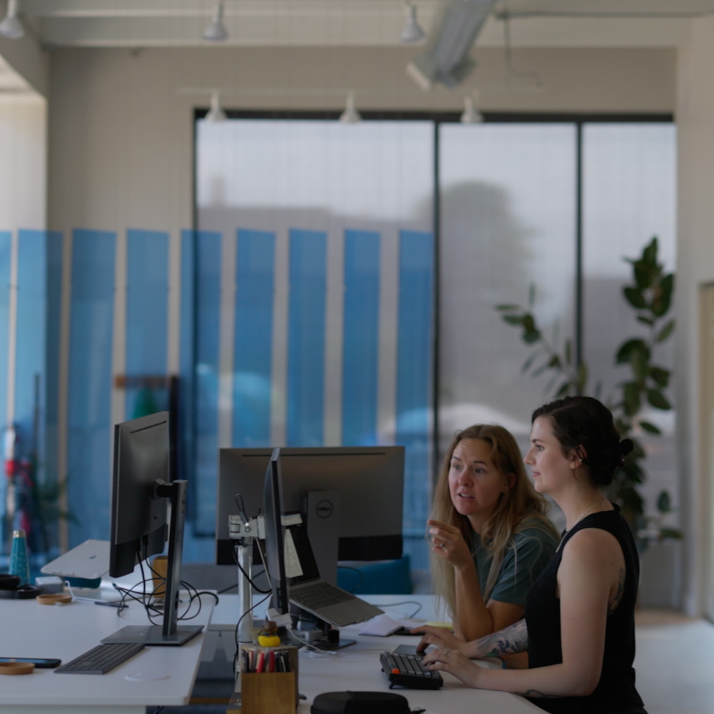 Sara and Andrea work over the results of a UX study for custom SaaS development project.