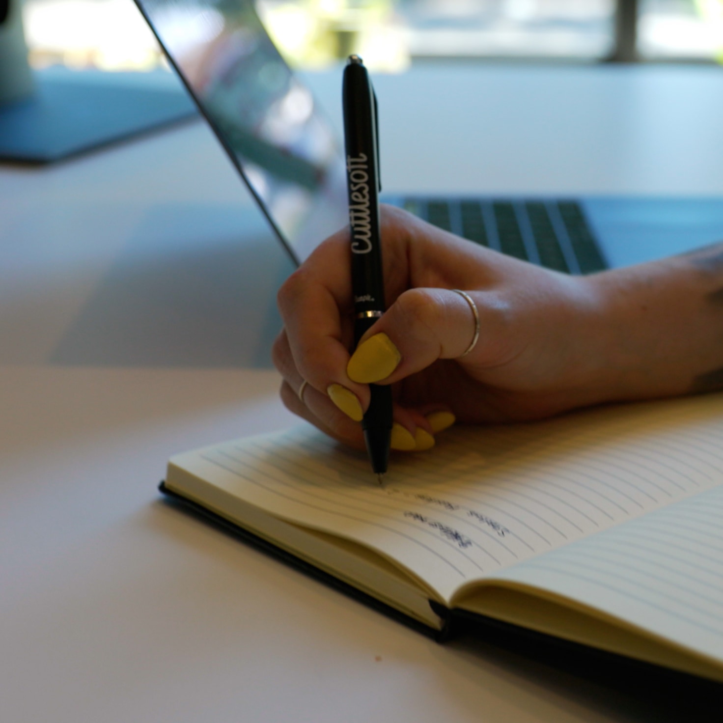 Andrea taking notes during a call for a software development project with one of our non-profit clients serving the healthcare and early childhood development industries.