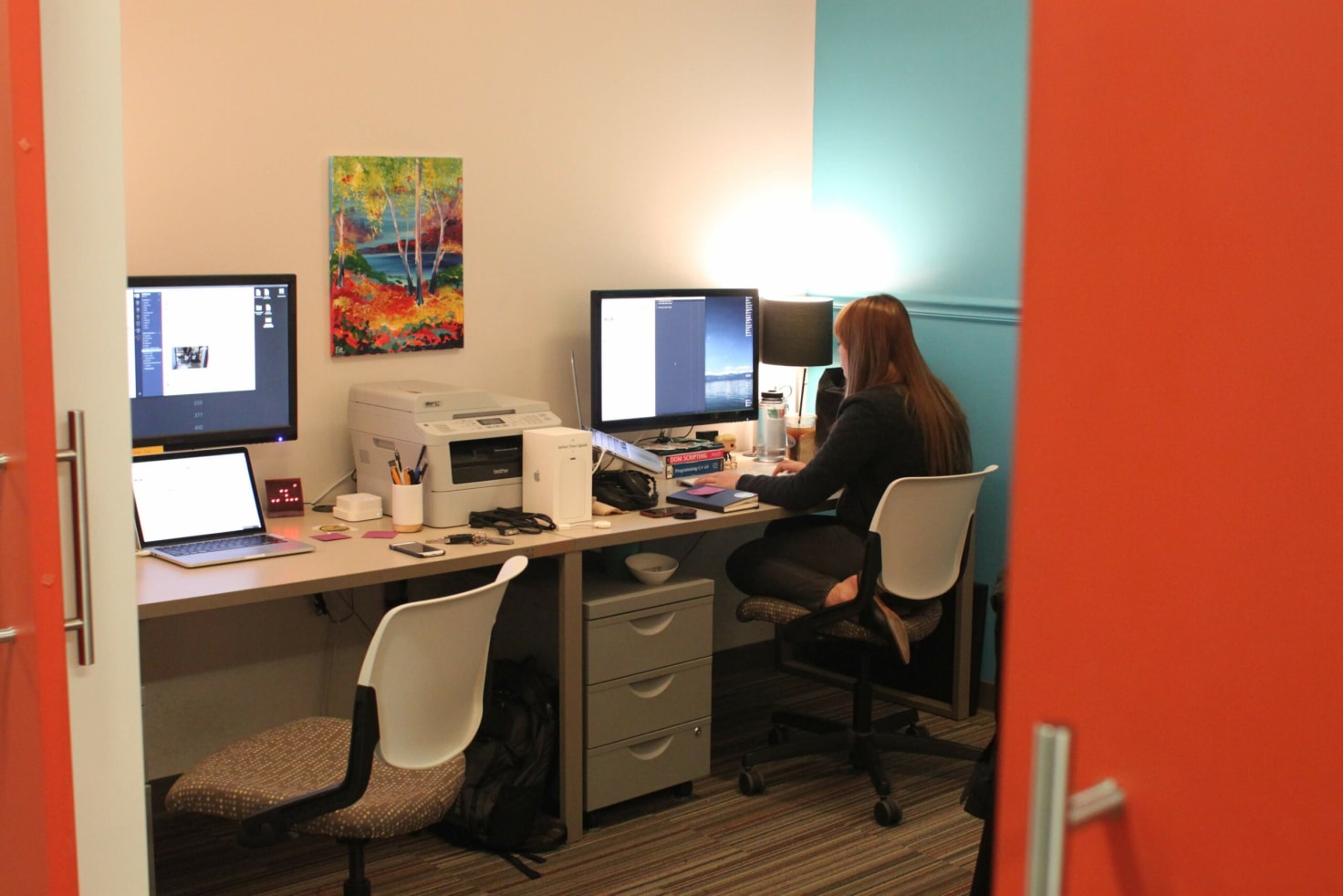 Our first 'real' office at Domi Station. Emily at work in our tiny space with the signature orange barn doors - where magic happened between ping pong matches and ramen breaks.